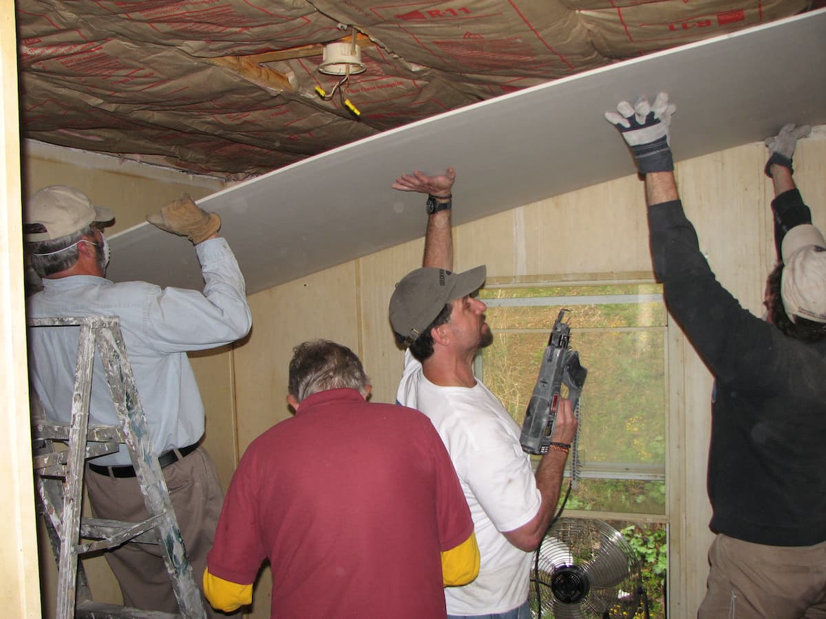 Vince Busby, General Contractor, making ceiling repairs during a mission trip to Appalachia.