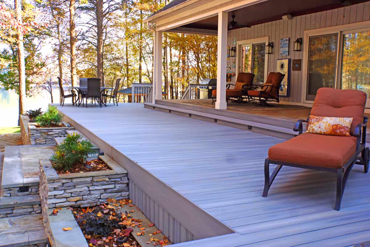 Fiberon deck with natural stone steps on Lake Norman by Distinctive Design + Build + Remodel.