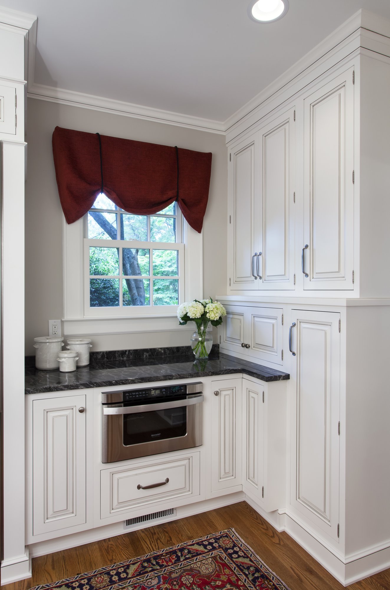 A microwave drawer under a window in a historic home in Myers Park renovated by Distinctive Design + Build + Remodel in Charlotte, NC.
