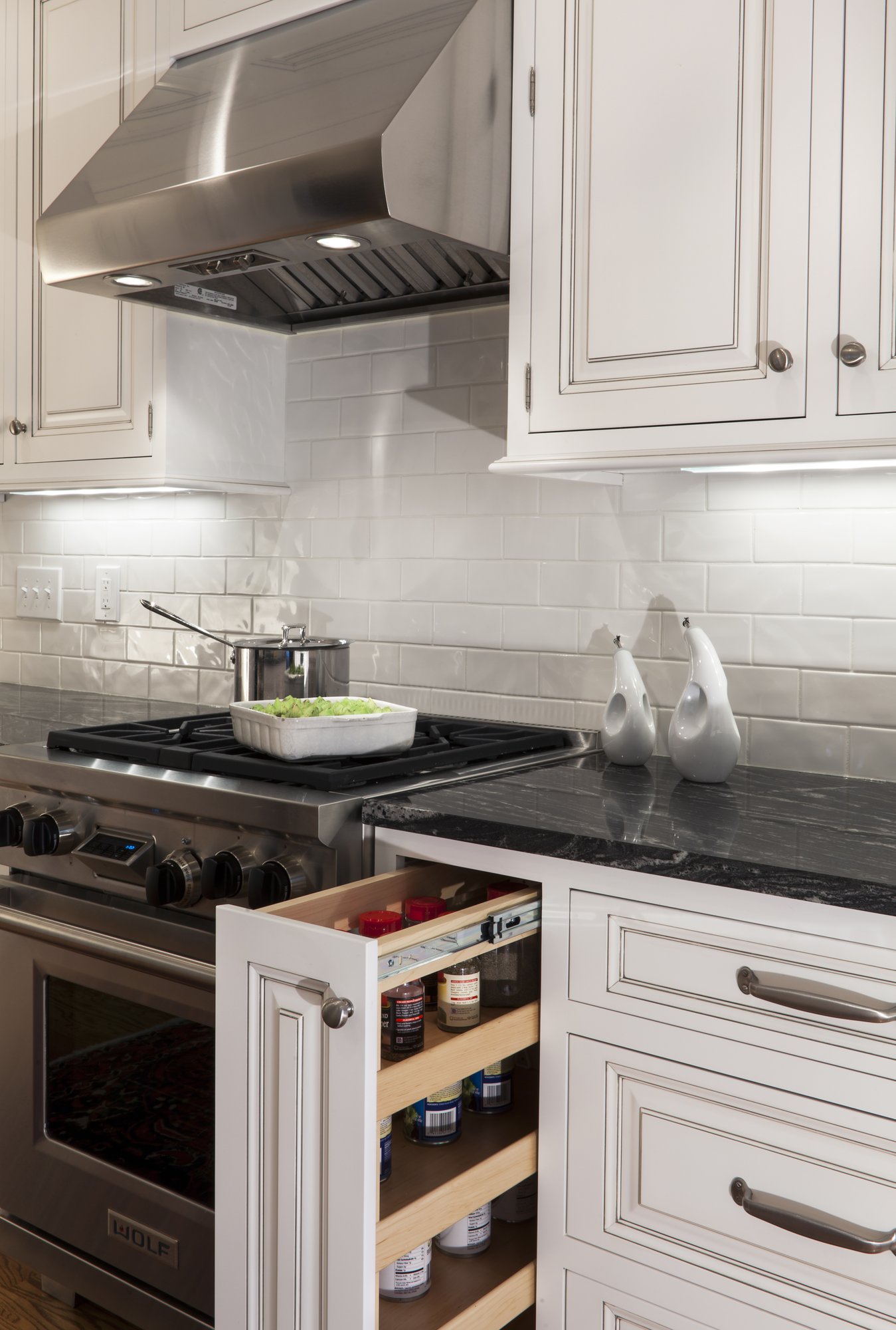 Pull-out spice rack in a Myers Park kitchen renovation by Distinctive Design + Build + Remodel in Charlotte, NC.