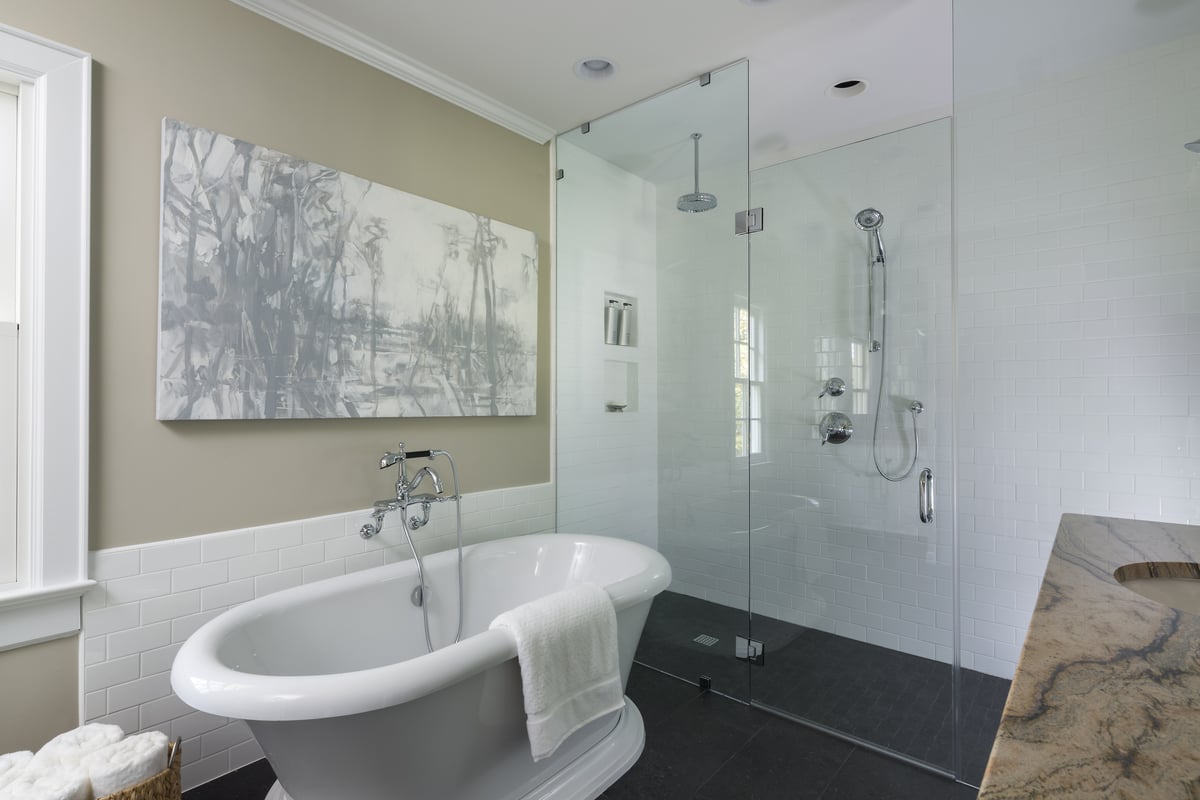 Primary bathroom remodel by Distinctive Design + Build + Remodel with barrier-free shower and free-standing tub in a historic home in the Eastover neighborhood of Charlotte, NC.