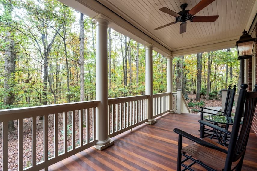 Porch renovation with new Ipe hardwood floor boards and composite railing in Waxhaw, NC by Distinctive Design + Build + Remodel.