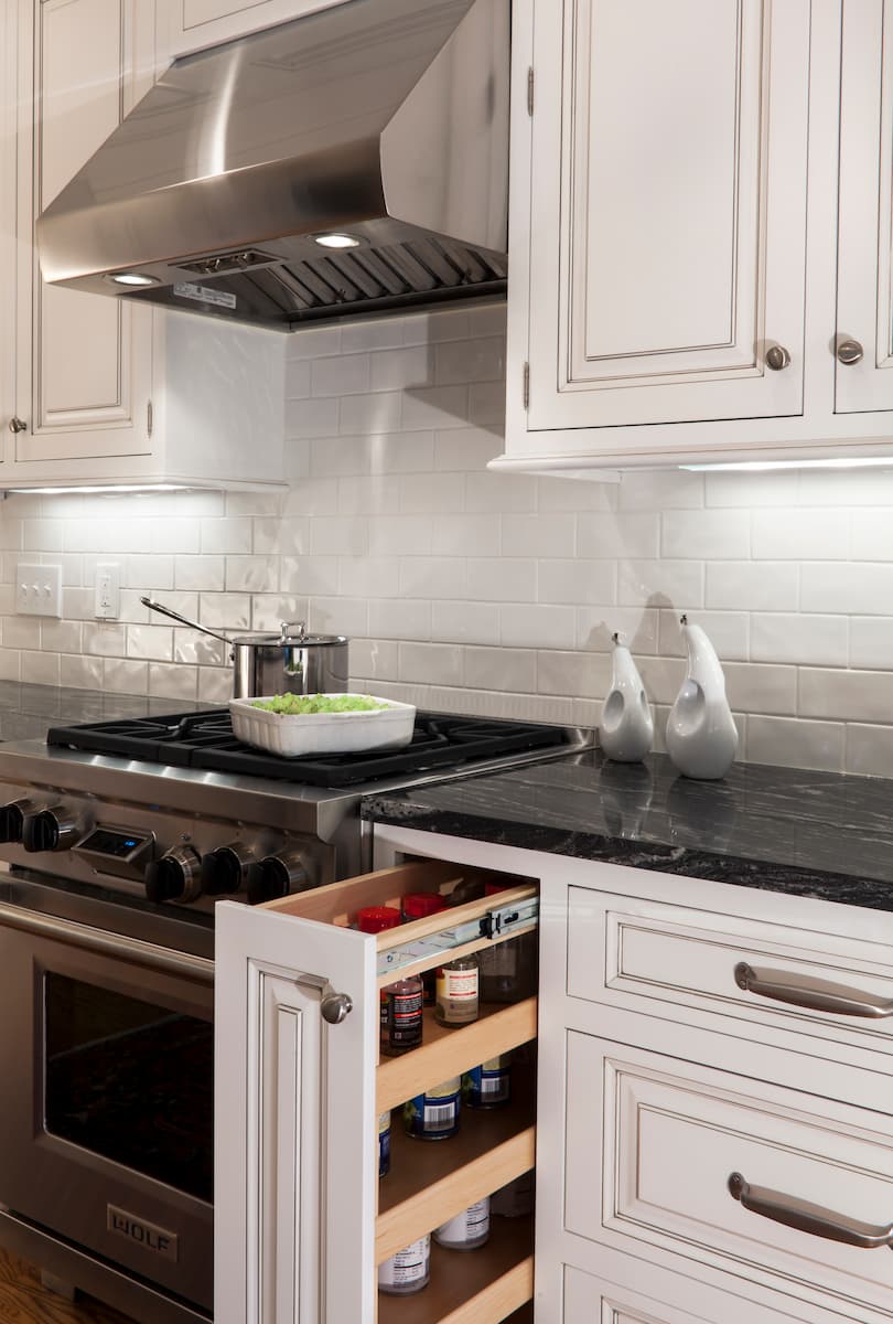 Pull-out spice rack in a Myers Park kitchen renovation by Distinctive Design + Build + Remodel in Charlotte, NC.