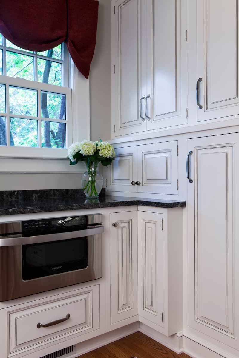 A microwave drawer under a window in a historic home in Myers Park renovated by Distinctive Design + Build + Remodel in Charlotte, NC.