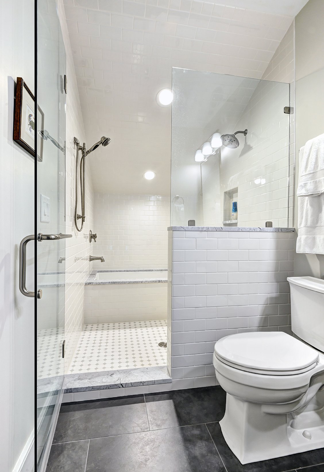 Attic space converted to bathroom with white and gray tile on Kiawah Island, SC by Distinctive Design + Build + Remodel.