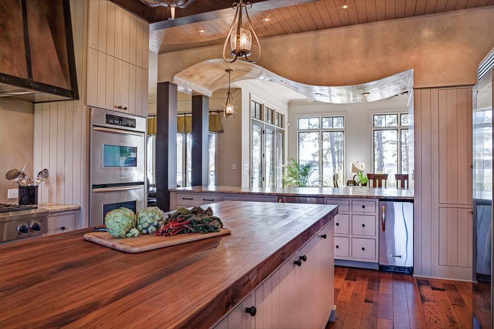 A dramatic corbel ceiling is a highlight in this Lake Norman kitchen remodel by Distinctive Design + Build + Remodel.