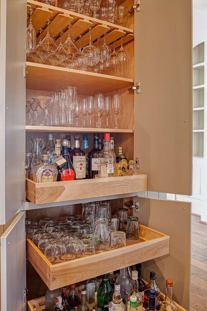 Custom bar cabinetry hidden inside a column in an award-winning Lake Norman, NC kitchen remodel by Distinctive Design + Build + Remodel.