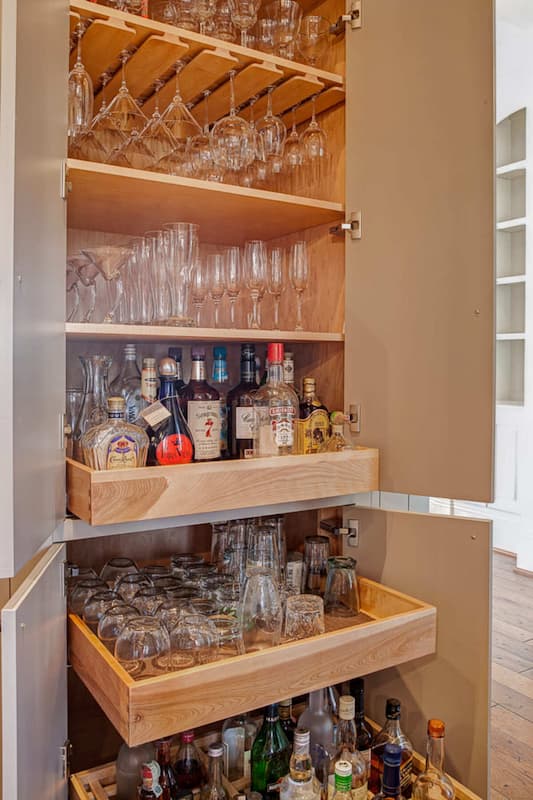 Custom bar cabinetry hidden inside a column in an award-winning Lake Norman, NC kitchen remodel by Distinctive Design + Build + Remodel.