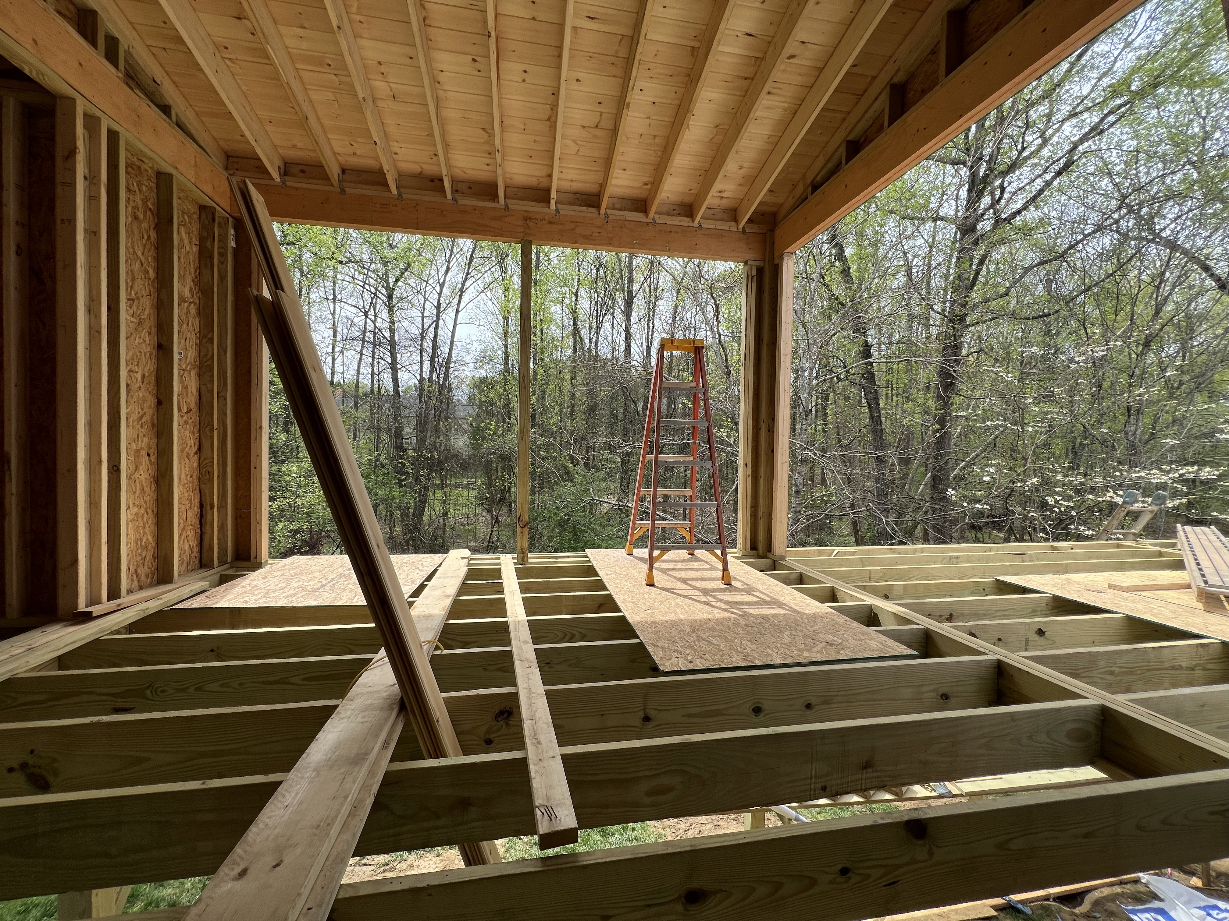 A screened porch under construction in Charlotte, NC by Distinctive Design + Build + Remodel.