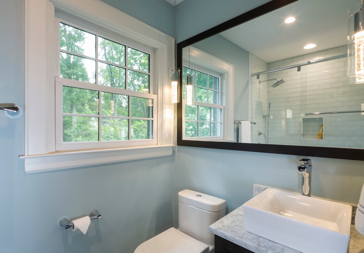 Award-winning bathroom remodel by Distinctive Design + Build + Remodel in a historic home in Myers Park with vessel sink and marble countertop in Charlotte, NC.