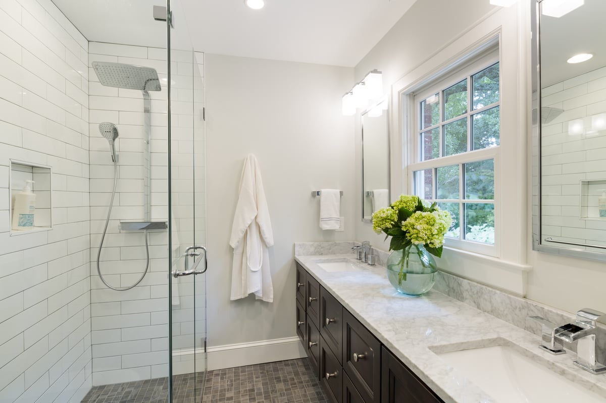 Award-winning primary bathroom remodel in the Myers Park neighborhood of Charlotte, NC with curb-less shower and floating vanity by Distinctive Design + Build + Remodel.