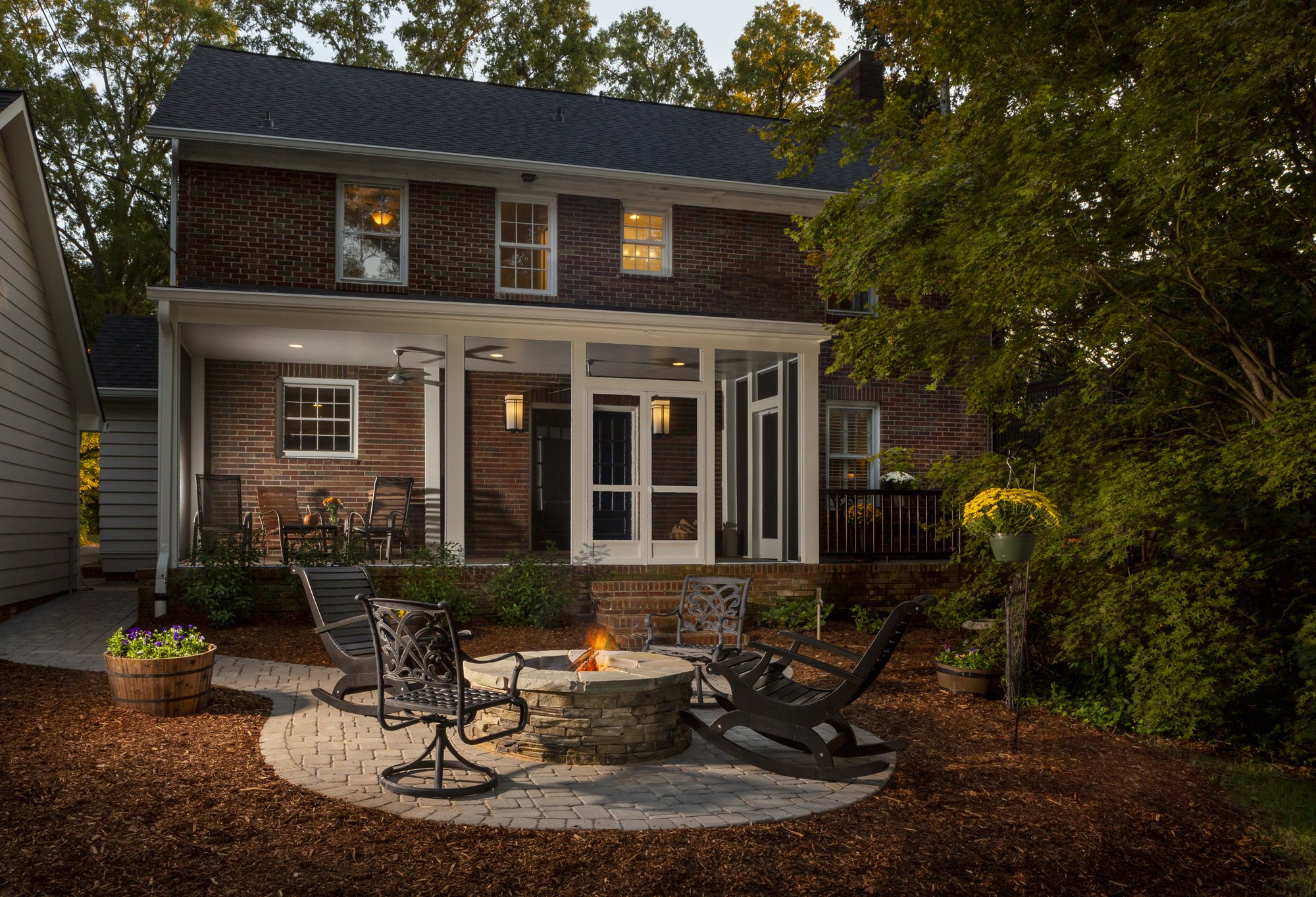 New covered porch with Screeneze and firepit in Myers Park by Distinctive Design + Build + Remodel.