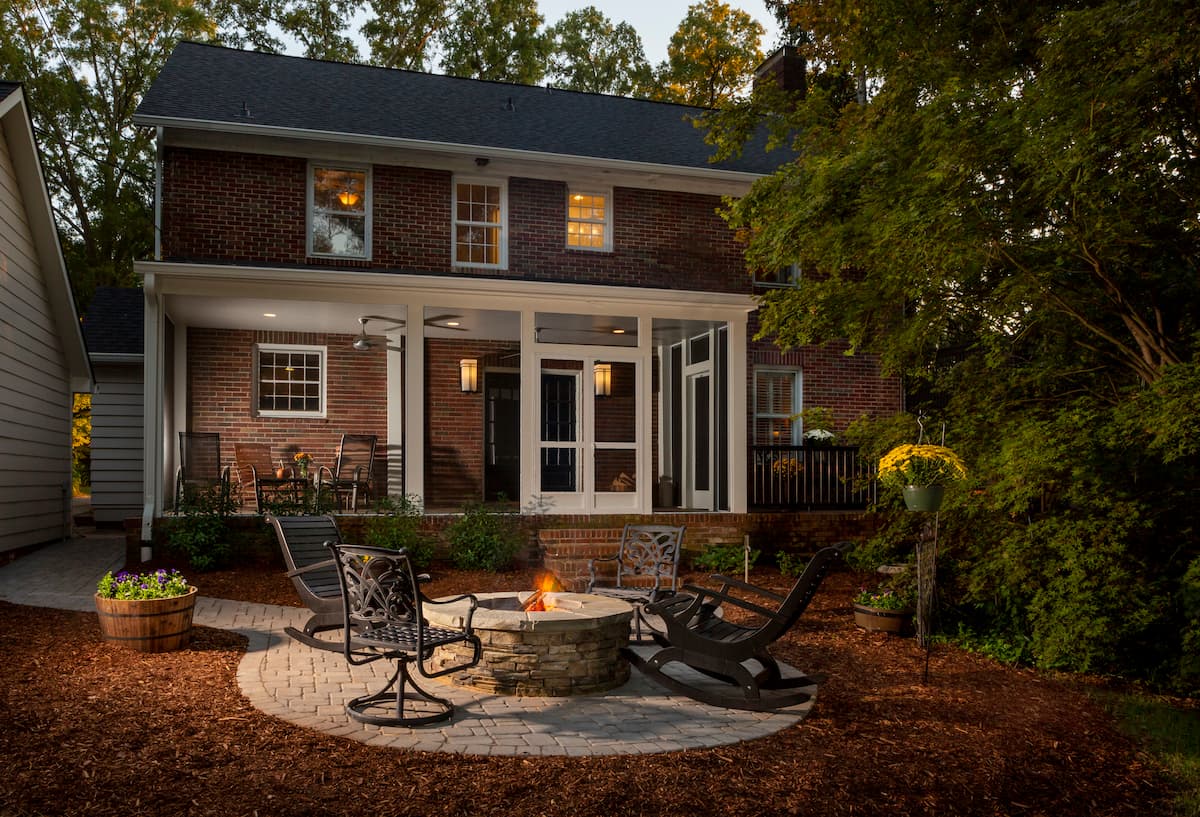 New covered porch with Screeneze and firepit in Myers Park by Distinctive Design + Build + Remodel.