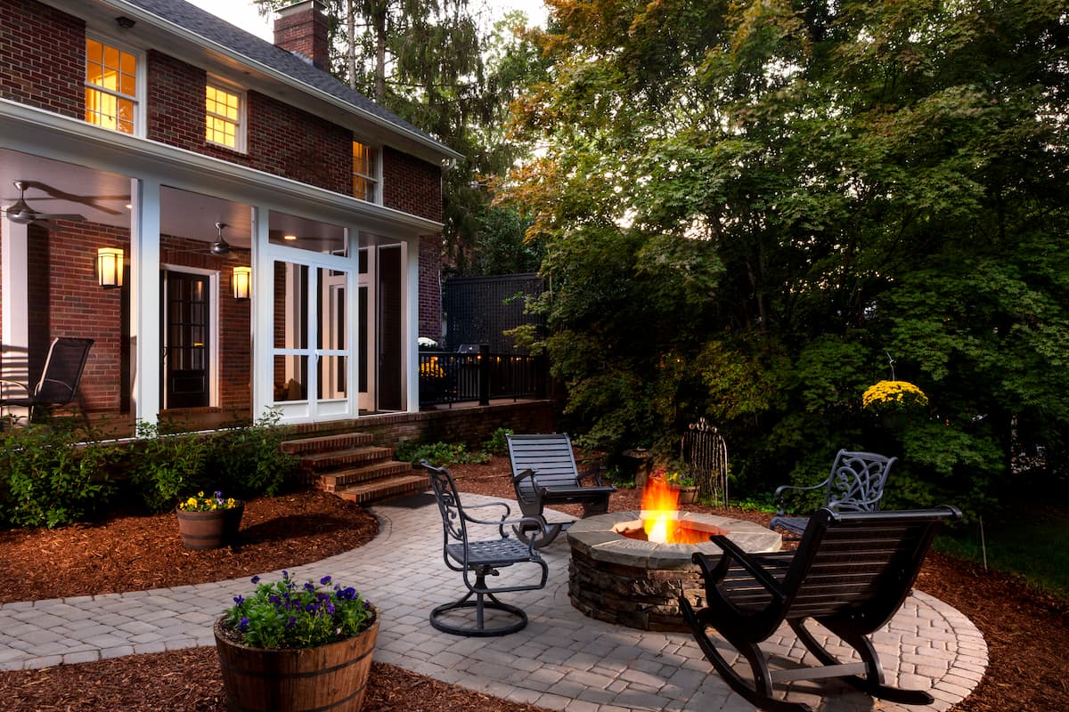 New screened porch and fire pit in the Myers Park neighborhood in Charlotte, NC by Distinctive Design + Build + Remodel.