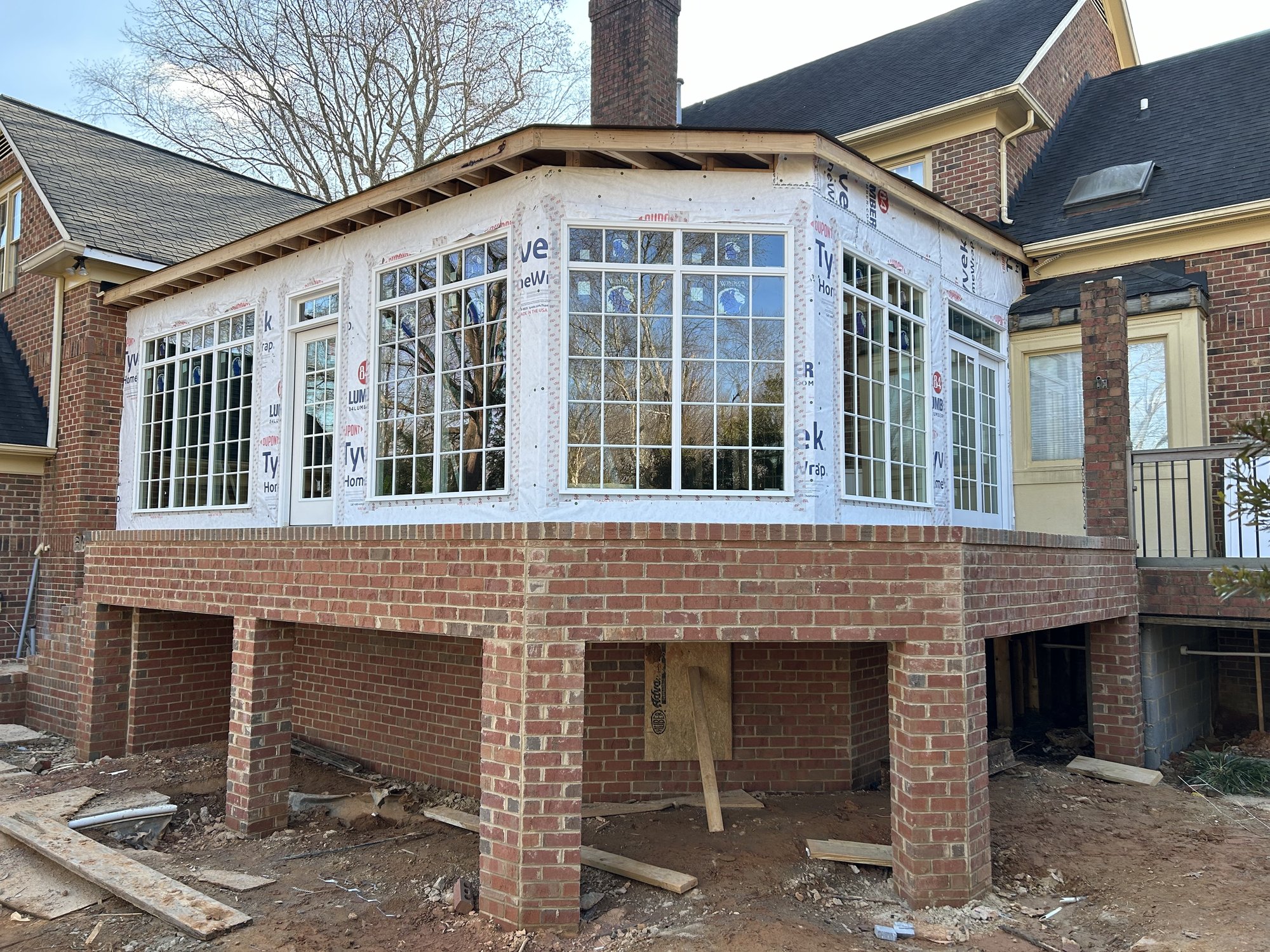 Sunroom addition under construction in Cramer Mountain, NC by Distinctive Design + Build + Remodel.