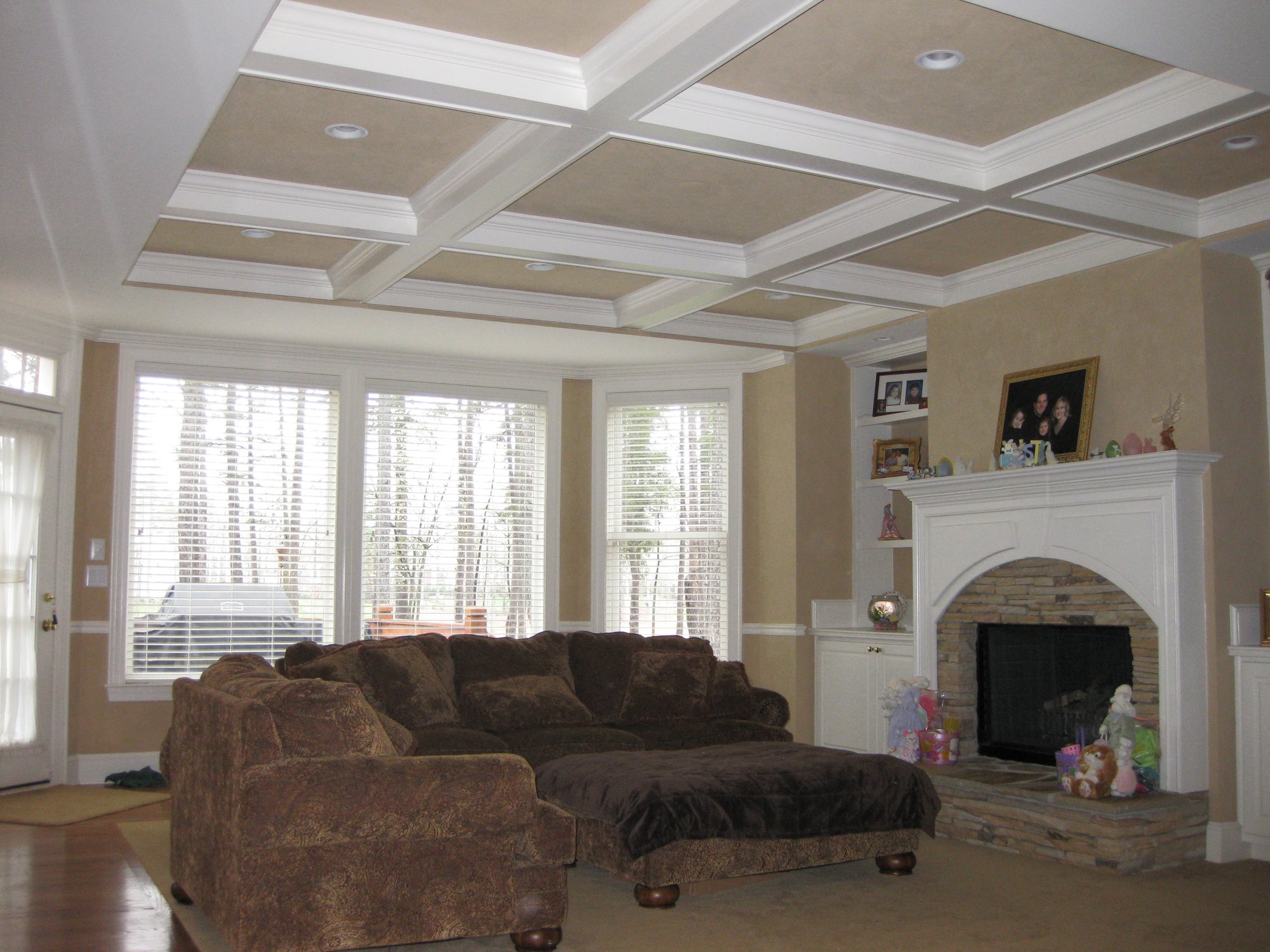 A ceiling is added to a two-story living room to create extra space for a playroom upstairs in Huntersville, NC by Distinctive Design + Build + Remodel.