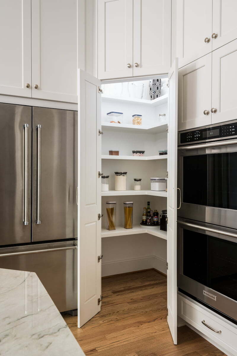 Secret pantry disguised to look like cabinetry in a kitchen remodel by Distinctive Design + Build + Remodel in Charlotte, NC.