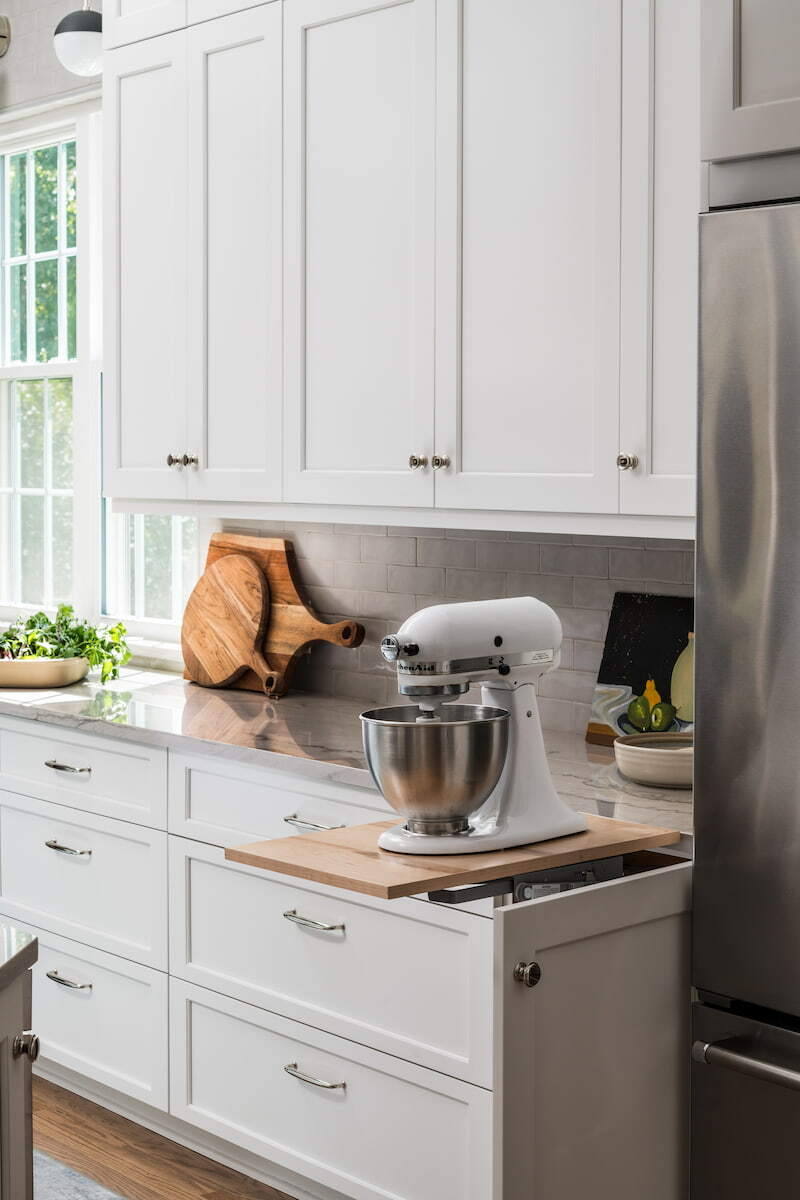 Mixer lift with white cabinets and quartz countertops in a kitchen remodel by Distinctive Design + Build + Remodel in Charlotte, NC