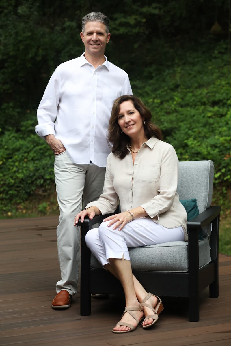 General Contractor, Vince Busby, and Principal Designer, Erin Dougherty outside on a deck.