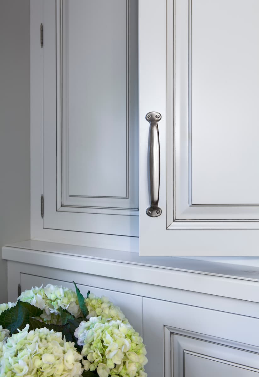 Inset cabinetry with raised panel doors and glazed finish in Myers Park historic home — remodeled by Distinctive Design + Build + Remodel in Charlotte, NC.