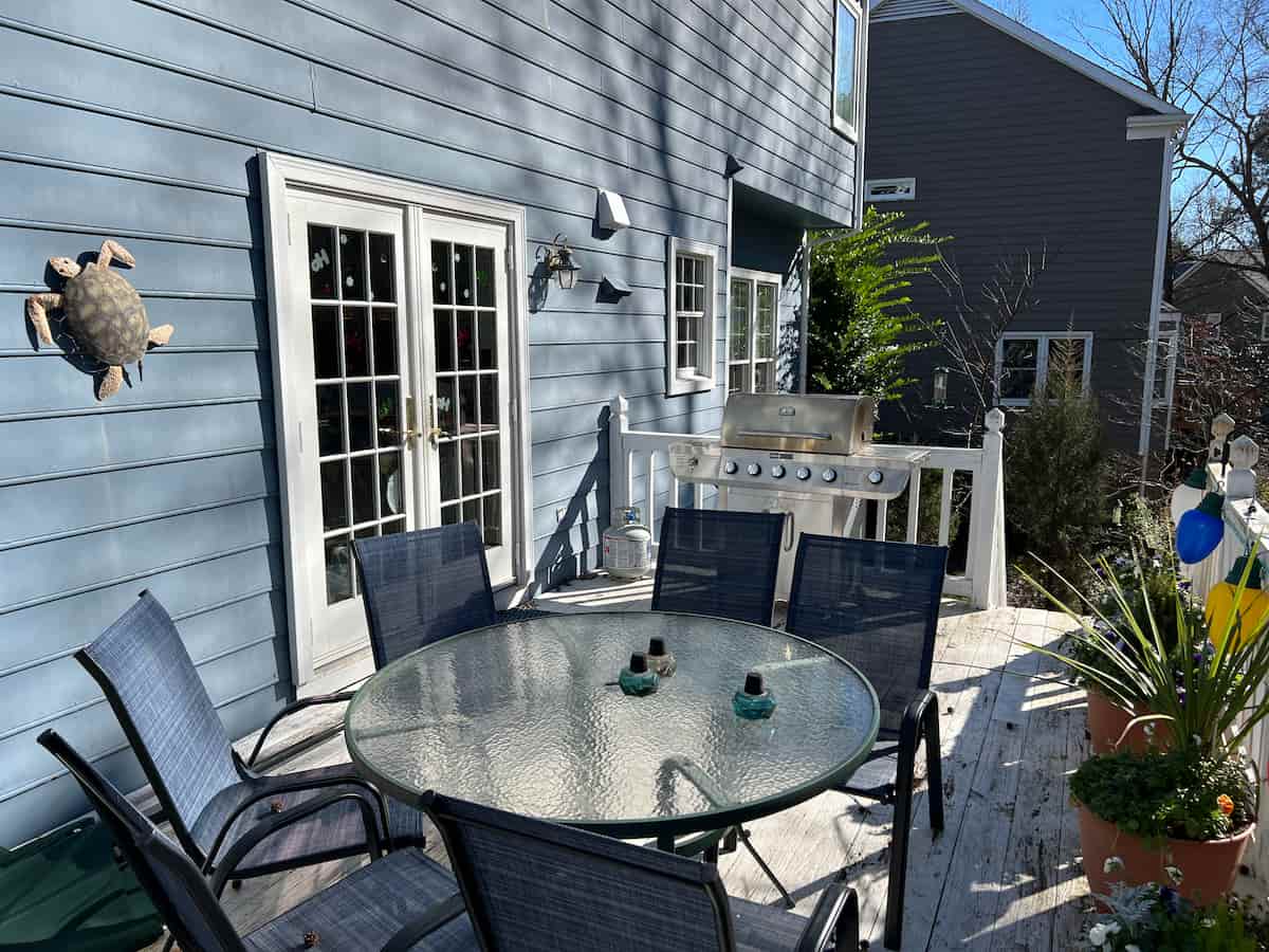 Deck before renovation and sunroom addition in Charlotte, NC by Distinctive Design + Build + Remodel.