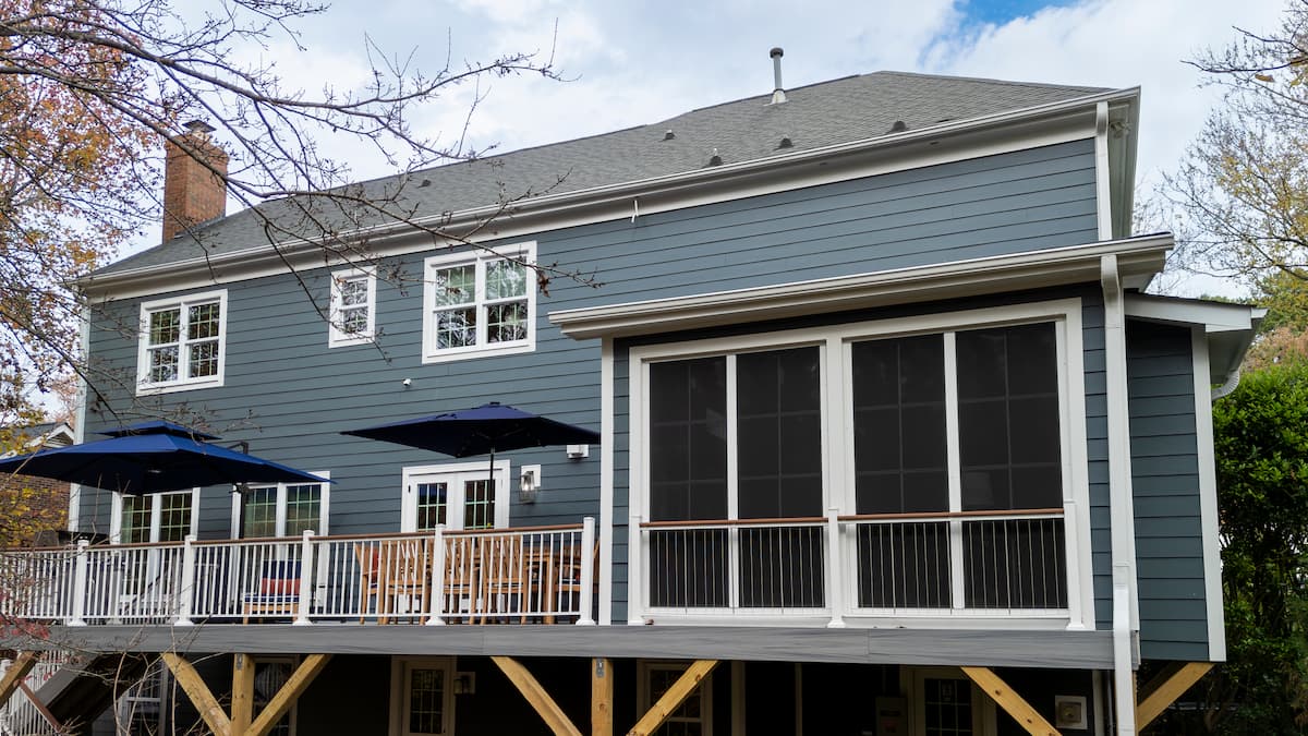 Sunroom addition with Eze Breeze windows and Trex decking by Distinctive Design + Build + Remodel in Charlotte, NC.