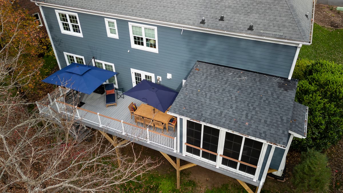 Aerial view of a Trex deck and sunroom addition with Eze Breeze windows in Charlotte, NC by Distinctive Design + Build + Remodel.