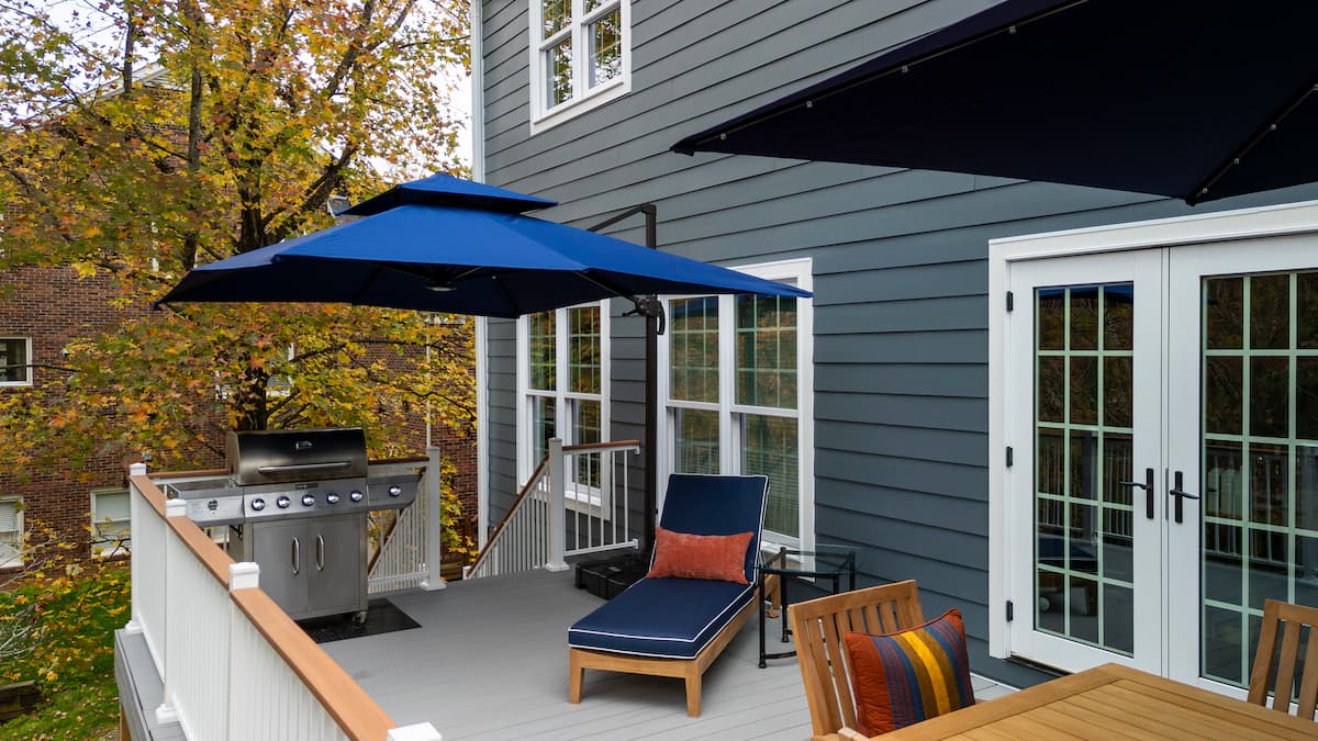 Trex decking and cocktail rail and James Hardie fiber cement siding in Charlotte, NC by Distinctive Design + Build + Remodel.