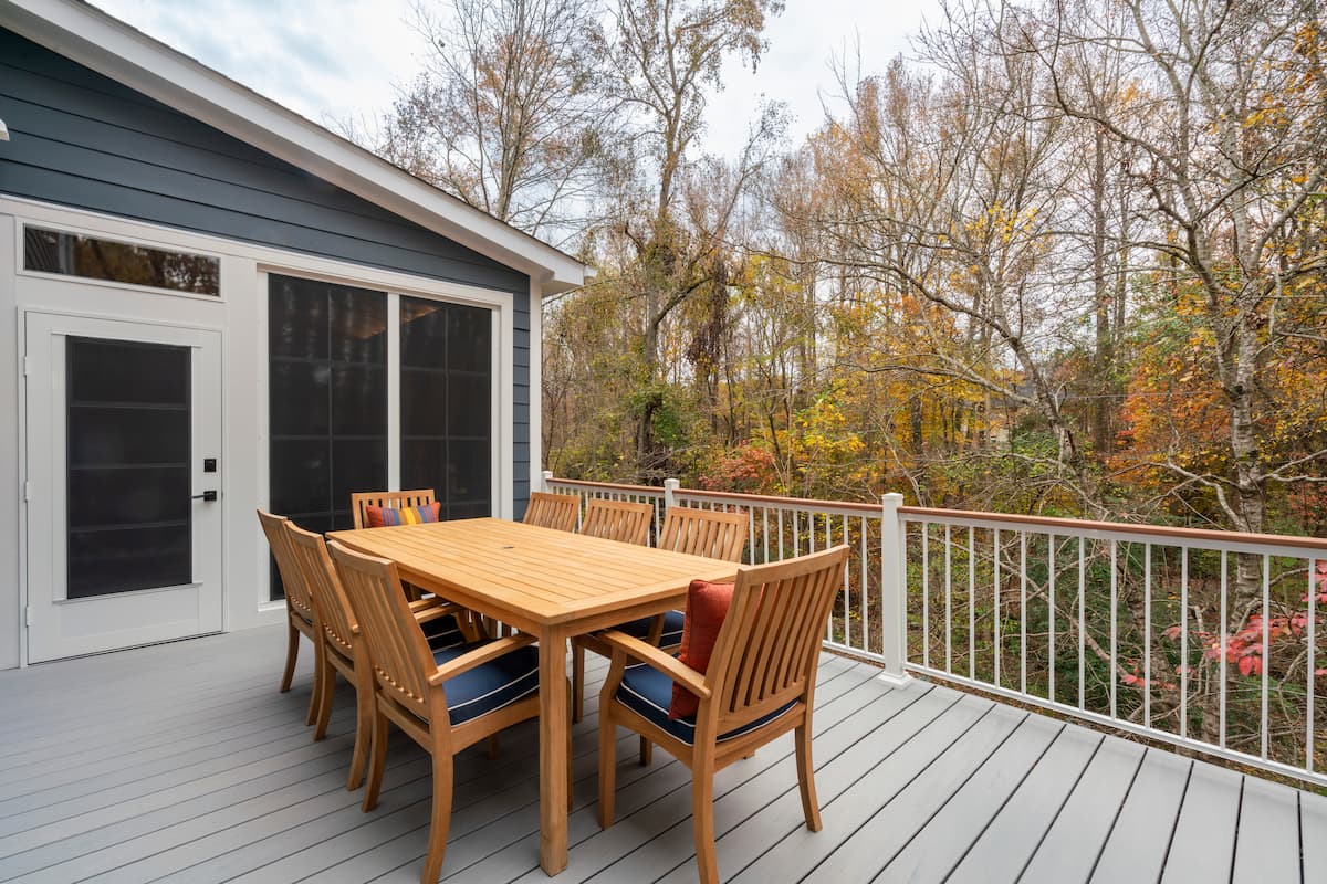 Trex deck in Charlotte, NC overlooking sloped backyard with leaves changing colors in the fall in Charlotte, NC by Distinctive Design + Build + Remodel.