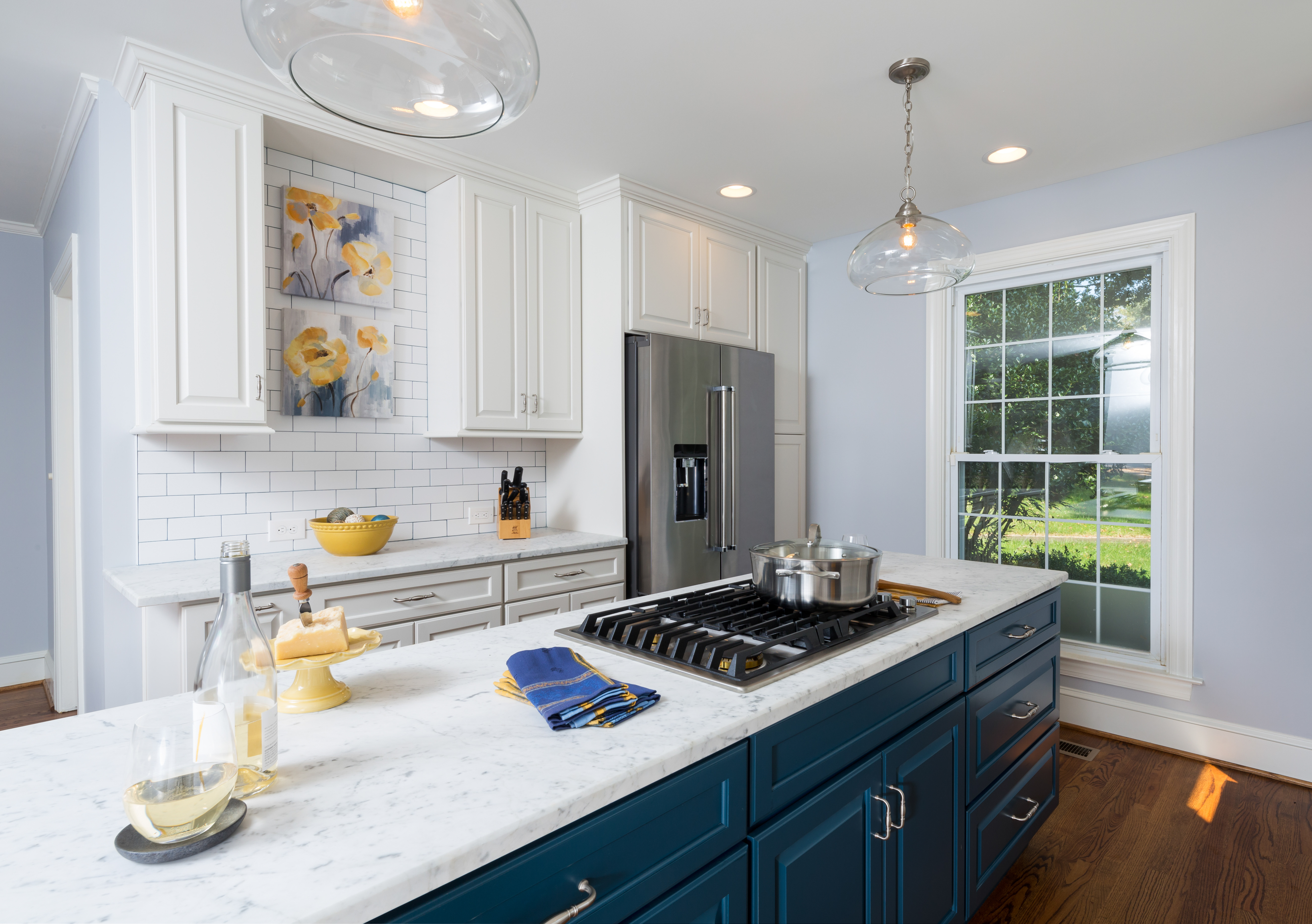 Kitchen remodel in Charlotte, NC with gas cooktop and downdraft on the blue island by Distinctive Design + Build + Remodel.