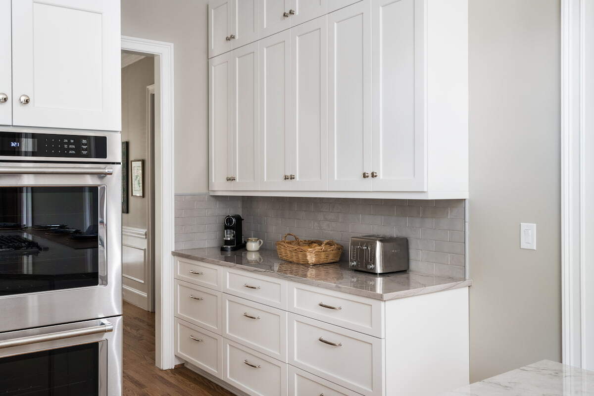 Coffee bar in a white kitchen remodeled by Distinctive Design + Build + Remodel in Ballantyne.