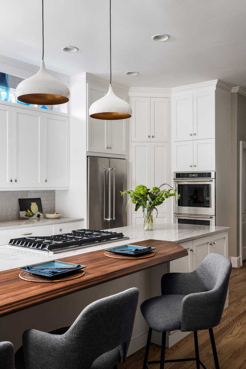 Walnut seating bar in a kitchen remodel by Distinctive Design + Build + Remodel in Charlotte, NC.