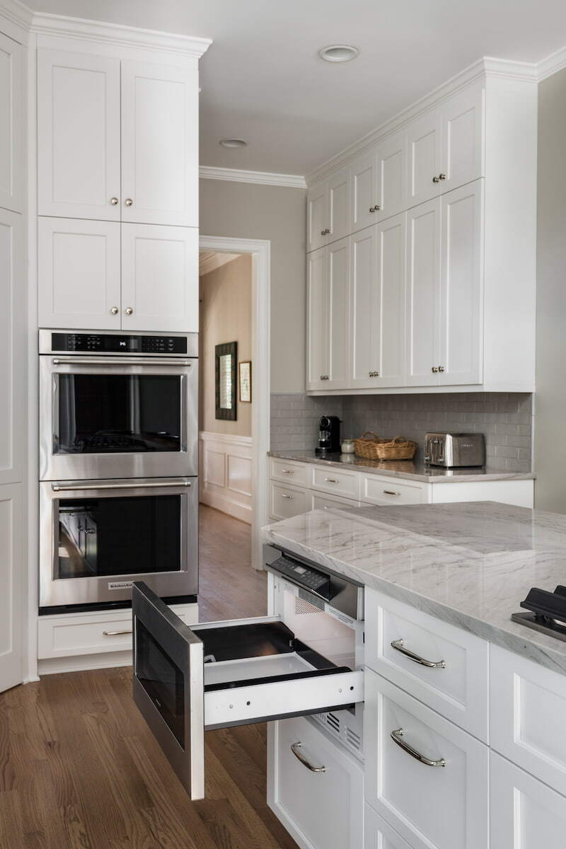 Double ovens and microwave drawer in a kitchen remodel in Charlotte, NC by Distinctive Design + Build + Remodel.