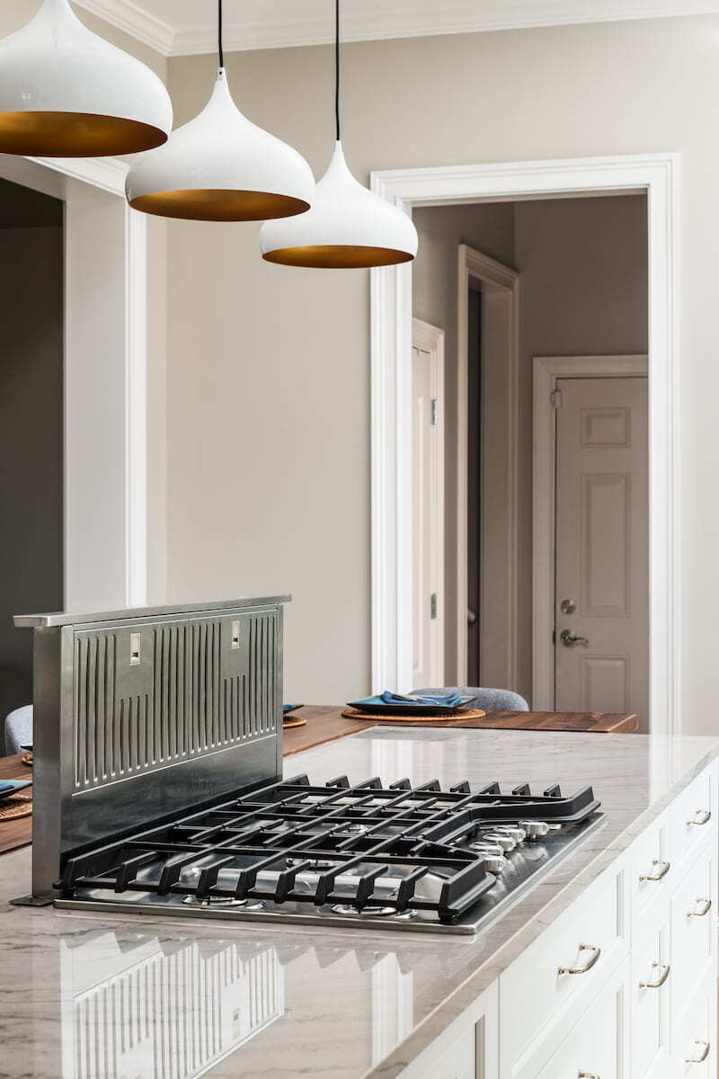 Gas cooktop with downdraft in a kitchen island remodeled by Distinctive Design + Build + Remodel in Charlotte, NC.