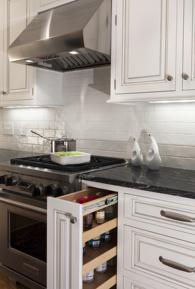 Pull-out spice rack next to Wolf range in Charlotte, NC kitchen remodel.