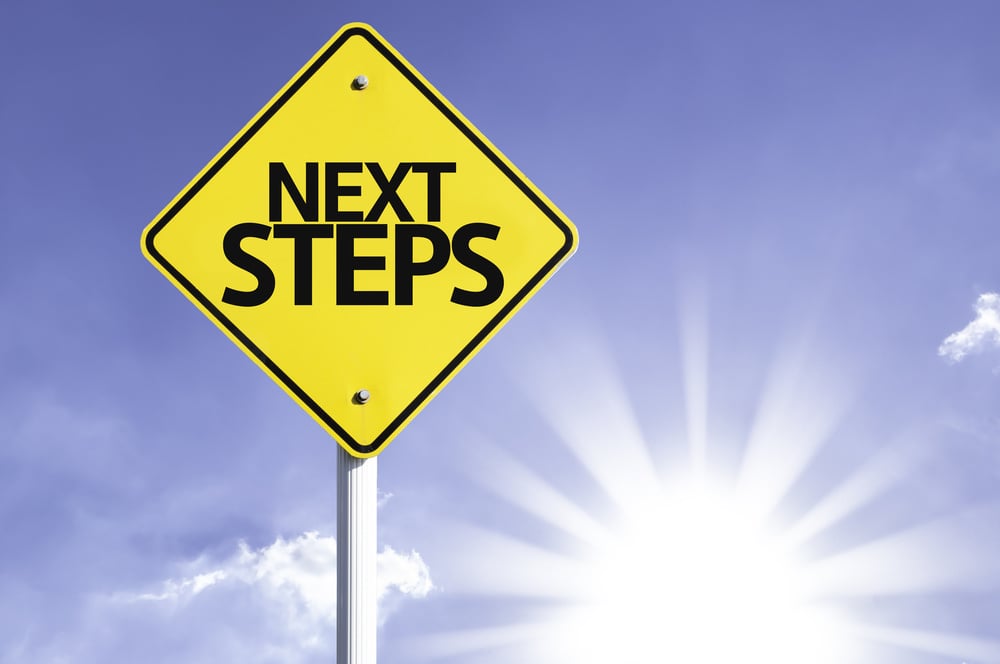 A yellow and black road sign that says next steps.